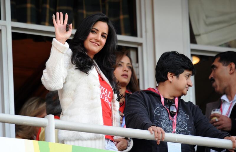 Indian Bollywood actress Katrina Kaif wears a Royal Challengers Bangalore T-shirt as she waves to the crowd while watching the second semi-final match of the IPL Twenty20 league between Royal Challengers Bangalore and Chennai Super Kings at The Wanderers Stadium in Johannesburg on May 23, 2009. Royal Challengers Bangalore beat Chennai Super Kings on May 23 by six wickets to reach the final against the Deccan Chargers scheduled for May 24. AFP PHOTO/Saeed KHAN - GETTY OUT (Photo by SAEED KHAN / AFP)