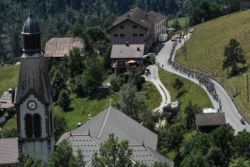 Cyclists ride through the village of Manigod during the 10th stage of the Tour de France between Annecy and Le Grand-Bornand. Jeff Pachoud / AFP