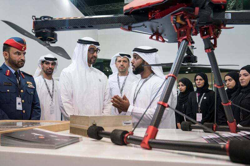 ABU DHABI, UNITED ARAB EMIRATES - February 27, 2018: HH Sheikh Mohamed bin Zayed Al Nahyan, Crown Prince of Abu Dhabi and Deputy Supreme Commander of the UAE Armed Forces (center L), visits the Khalifa University and ETIC (Emirates Technology & Innovation Competition) stand while touring the Unmanned Systems Exhibtion and Conference (UMEX) 2018 at the Abu Dhabi National Exhibition Centre (ADNEC). Seen with HE Dr Arif Al Hammadi, Executive Vice President of Khalifa University (back C). 
( Ryan Carter for the Crown Prince Court - Abu Dhabi )
---