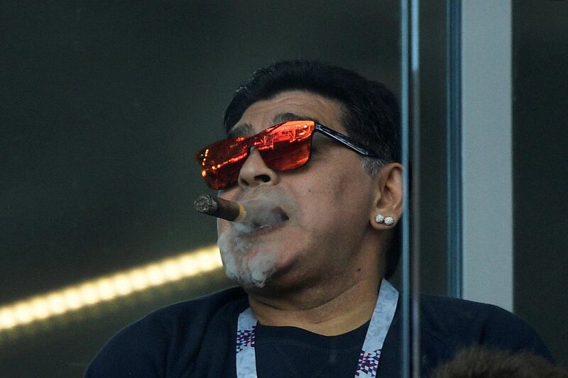 (FILES) In this file picture taken on June 16, 2018 Argentina's football legend Diego Maradona smokes a cigare as he attends the Russia 2018 World Cup Group D football match between Argentina and Iceland at the Spartak Stadium in Moscow. Argentine football legend Diego Maradona turns 60 on October 30, 2020.   - RESTRICTED TO EDITORIAL USE - NO MOBILE PUSH ALERTS/DOWNLOADS
 / AFP / Juan Mabromata / RESTRICTED TO EDITORIAL USE - NO MOBILE PUSH ALERTS/DOWNLOADS
