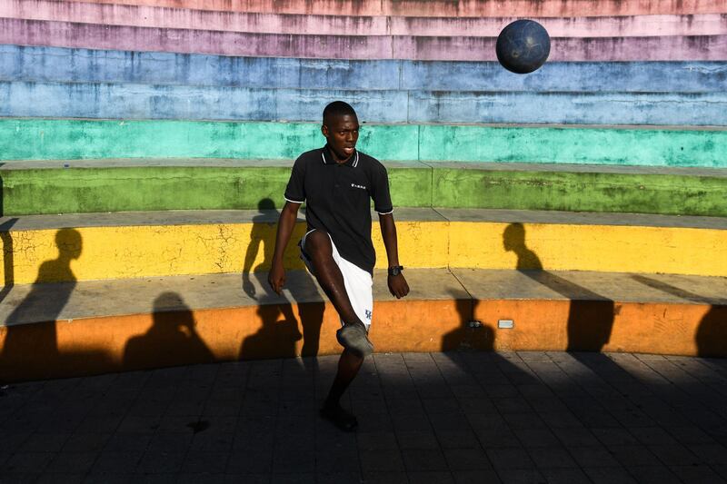 A man plays football in the Haitian capital Port-au-Prince. AFP