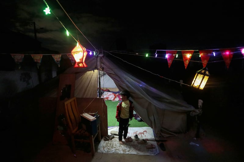 Displaced Palestinians in Rafah decorate their tent in preparation for the start of Ramadan. Getty Images