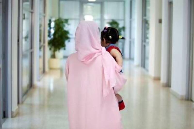 A mother holds her 10-month-old baby who was born in Dubai Central Jail. (Sarah Dea/ The National)