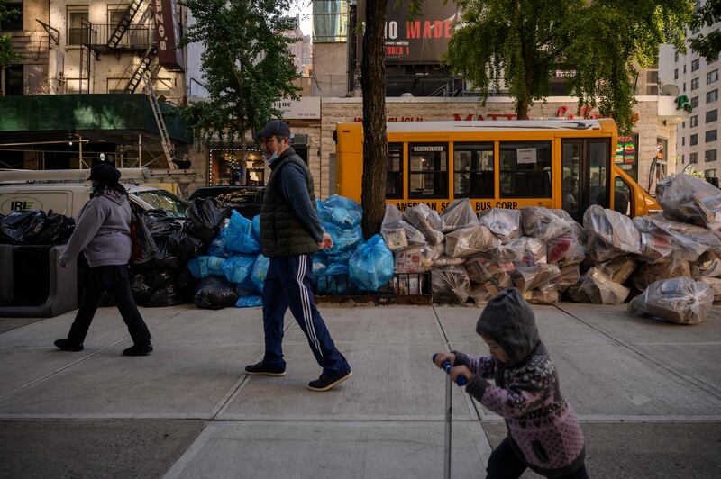 Pedestrians pass rubbish bags on a street in Manhattan in 2021. AFP