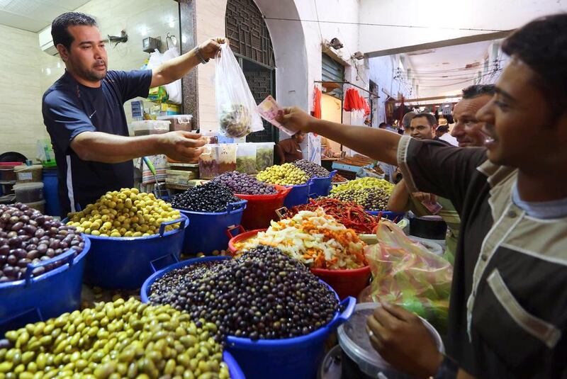 Libyan men shop for olives and pickles from a vendor in downtown Tripoli before breaking their fast during Islam’s holy fasting month of Ramadan on June 29, 2014.  Mahmud Turkia/AFP Photo