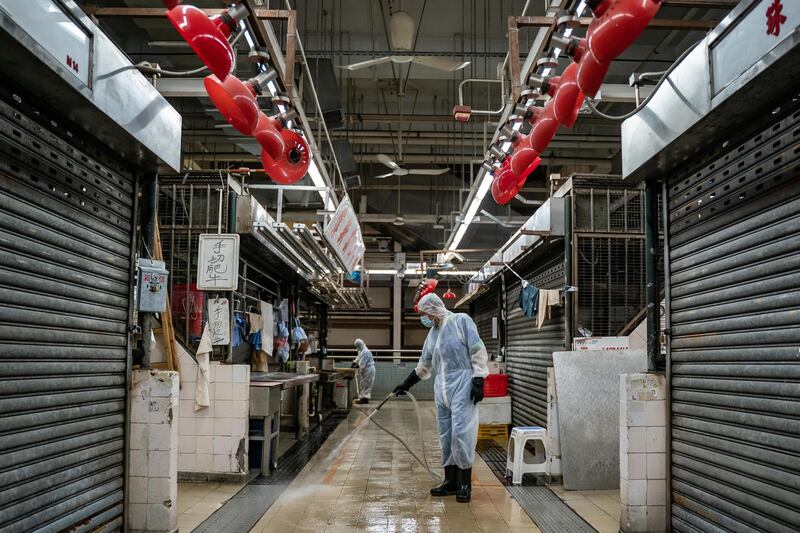 A Food and Environmental Hygiene Department contractor takes part in cleaning and disinfecting of a wet market in Hong Kong. Getty Images