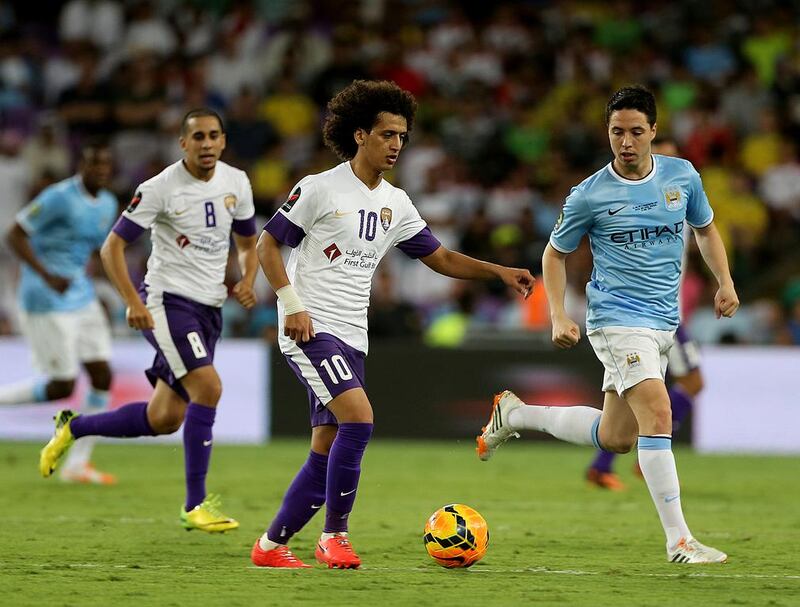 Omar Abdulrahman, centre, of Al Ain moves past Samir Nasri of Manchester City during their friendly at the Hazza bin Zayed Stadium in Al Ain on May 15, 2014. Satish Kumar / The National