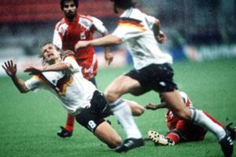 UAE captain Abdulrahman Mohammed looks on as West Germany's striker Jurgen Klinsmann is fouled.