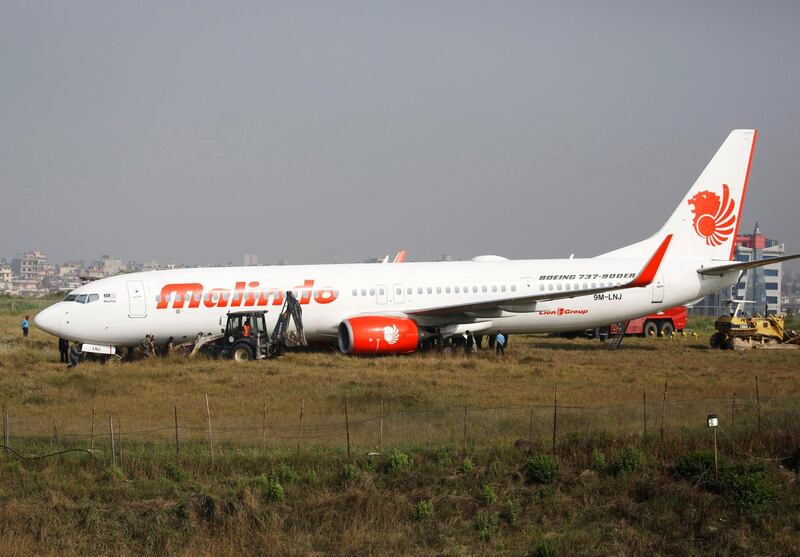 Officials check an aircraft belonging to Malindo Air that skidded off the runway during take off last night at Tribhuvan International Airport in Kathmandu, Nepal April 20, 2018. REUTERS/Navesh Chitrakar