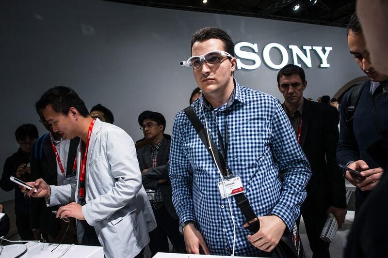 Visitors sample Sony wearable smart glasses. David Ramos / Getty Images