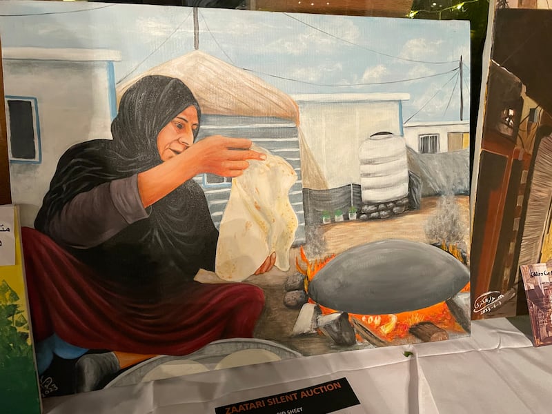 A painting by a Syrian refugee of a woman baking in the Zaatari refugee camp.