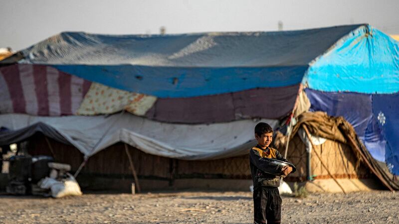 A child stands in front of tents at the camp. It lies in the village of Kasra Faraj in the southern countryside of Raqqa.