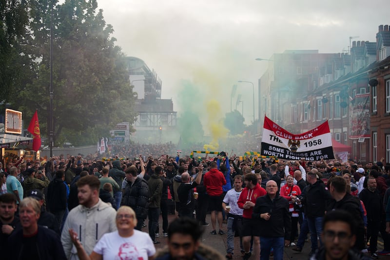 Fans take part in an organised protest march outside Old Trafford ahead of Manchester United match against Liverpool on August 22, 2022. PA