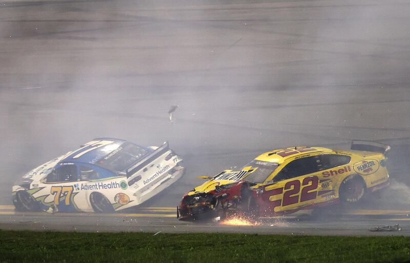 Team Penske's Joey Logano (No 22) veers off the track with Jamie McMurray of Spire Motorsports in front. AFP