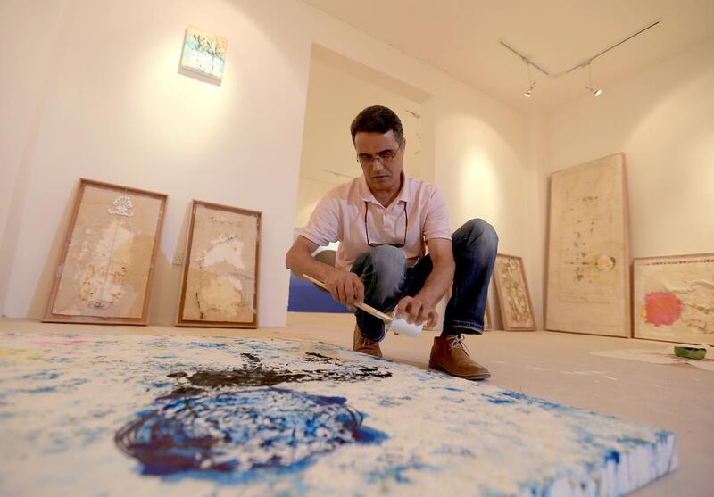Mohammed Quraish, a resident artist from Canada working with paper, iron and ink at Art Hub Liwa. Ravindranath K / The National