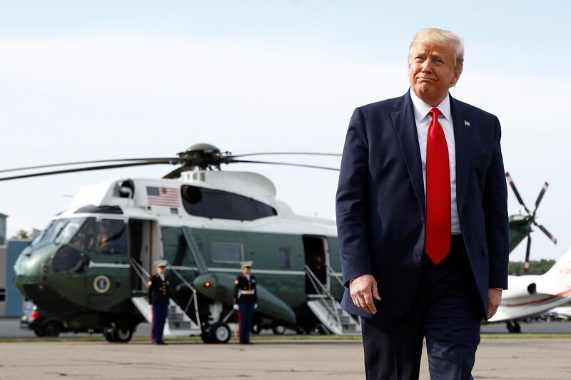 President Donald Trump walks to reporters to speak with them before boarding Air Force One at Morristown Municipal Airport in Morristown, N.J., Thursday, Aug. 15, 2019, en route to a campaign rally in Manchester, N.H. (AP Photo/Patrick Semansky)