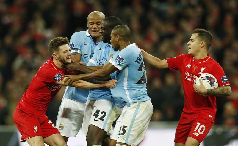 Manchester City's Yaya Toure clashes with Liverpool's Adam Lallana. Action Images via Reuters / Paul Childs