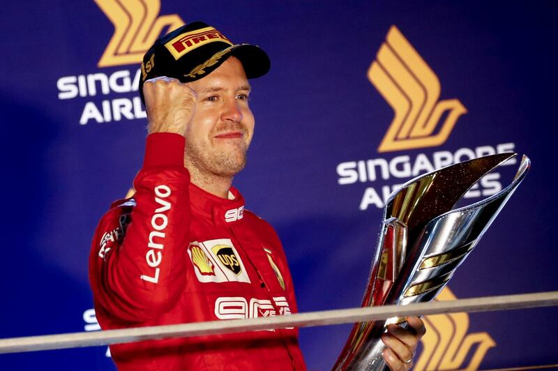 epa07861507 Winner German Formula One driver Sebastian Vettel of Scuderia Ferrari reacts with his trophy after winning the Singapore Formula One Grand Prix in Singapore, 22 September 2019.  EPA/DIEGO AZUBEL