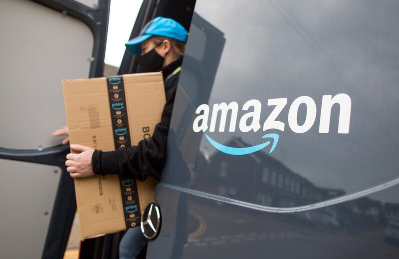 An Amazon.com Inc. delivery driver carries a customer order from the back of a delivery van in Westcliff-on-Sea, U.K., on Thursday, Nov. 26, 2020. With Black Friday almost underway, equity traders are bracing for a holiday season where brick-and-mortar businesses that lack strong digital platforms could suffer. Photographer: Chris Ratcliffe/Bloomberg