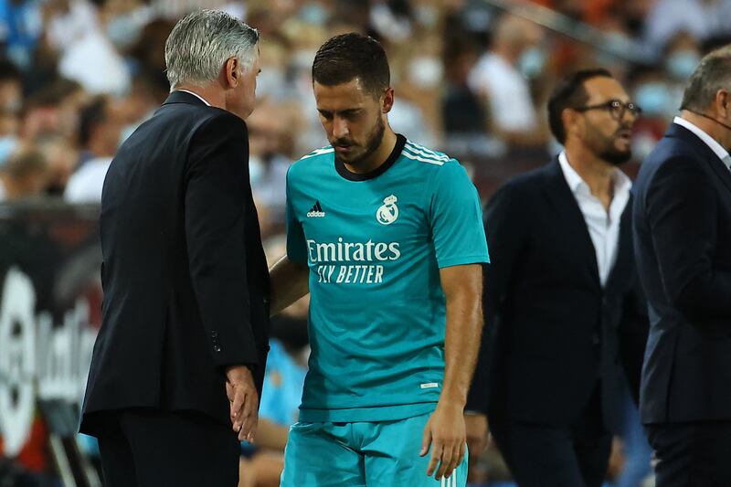 Real Madrid forward Eden Hazard walks past Carlo Ancelotti as he leaves the pitch. AFP
