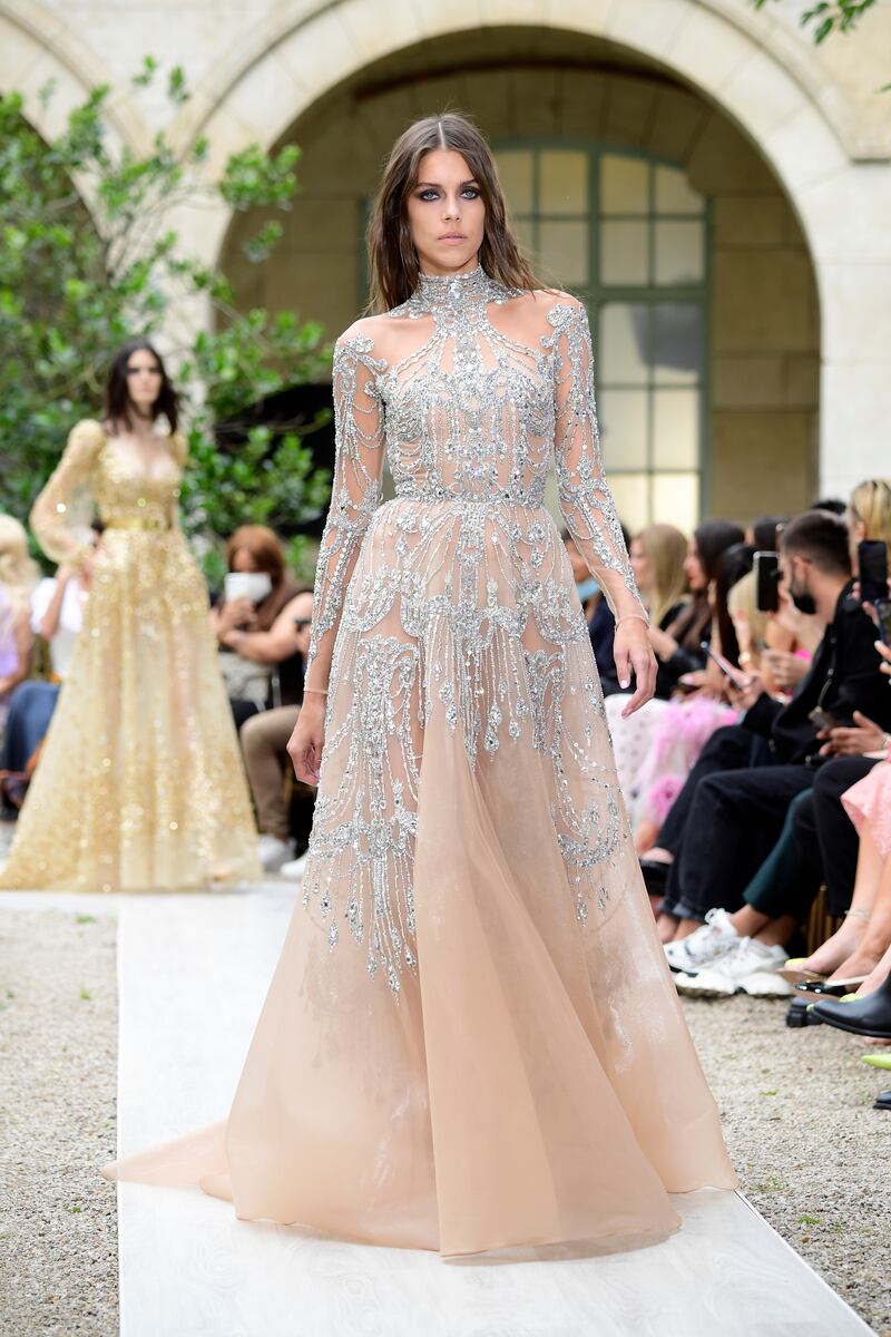 Models wore delicate, crystal-adorned masks, inspired by Venice's carnival history, as they presented the Lebanese designer's imaginings for autumn/winter 2021-2022 in the romantic courtyard of the Lycee Louis-le-Grand in Paris. Getty