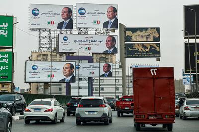 Motorists drive past campaign billboards of Egypt's President Abdel Fattah El Sisi in Cairo. AFP