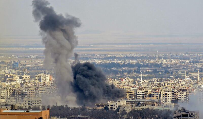 A picture taken from a government-controlled area on the outskirts of Harasta on the northeastern suburbs of Damascus on February 28, 2018, shows smoke rising from areas targeted by Syrian army shelling in the towns of Douma and Harasta. AFP