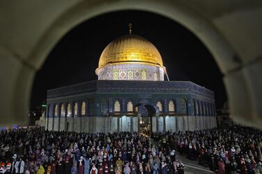 Palestinian devotees pray outside the Dome of the Rock in Jerusalem's Al Aqsa Mosque compound on Saturday. AFP