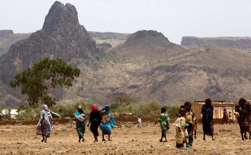 Sudanese villagers walk in the war-torn town of Golo in the thickly forested mountainous area of Jebel Marra in central Darfur on June 19, 2017. The town was a former rebel bastion which was recently captured by Sudanese government forces.
The United States' top envoy in Sudan visited Golo on June 19, 2017 on the second day of his four-day trip to Darfur to assess security in the war-torn region as the UN prepares to downsize its 17,000-strong peacekeeping force. 
His visit also comes just weeks before President Donald Trump's administration decides whether to permanently lift a two-decades old US trade embargo on Sudan. / AFP PHOTO / ASHRAF SHAZLY