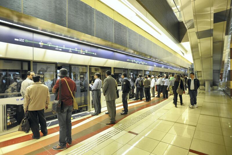 Commuters wait to take the Metro.