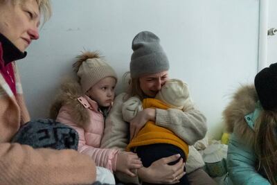 A woman whose husband was killed in the shelling cries on the floor of a corridor in a hospital in Mariupol. AP Photo