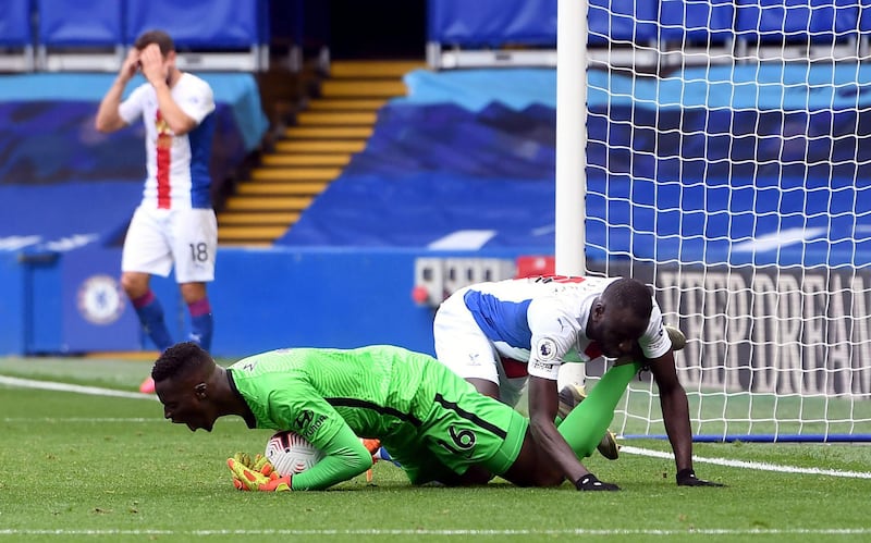 Chelsea goalkeeper Edouard Mendy collects the ball under pressure from Crystal Palace's Cheikhou Kouyate. PA