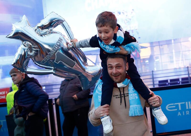 Manchester City fans celebrate winning the Premier League. Reuters