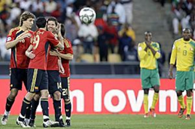 Xabi Alonso is surrounded by his Spain teammates after his free kick in extra time earned his country a 3-2 victory over South Africa to claim third place at the Confederations Cup.