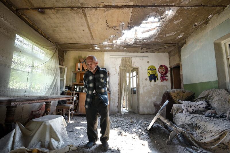 Aram Vardazaryan walks inside his home which suffered of bombing attacks on July 18, 2020, in the village of Aygepar, Tavush region, recently damaged by shelling during armed clashes on the Armenian-Azerbaijani border. - Russia said on July 17, 2020, it is prepared to mediate peace talks between ex-Soviet rivals Armenia and Azerbaijan after fighting escalated along their shared border. (Photo by Karen MINASYAN / AFP)