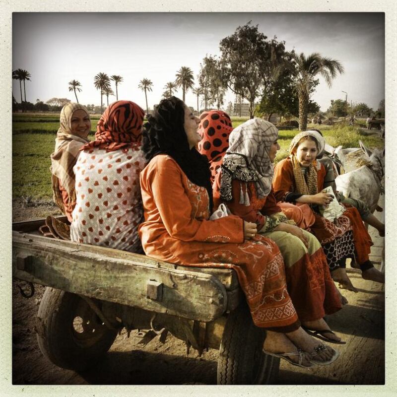 Women ride home on the back of a donkey cart in a village in Giza, Egypt. Photo by Tara Todras-Whitehill (@taratwphoto), April 2013.