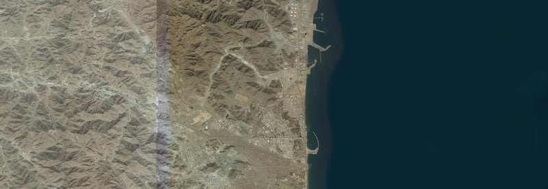 Fujairah is on the east coast of the UAE and is known for its beaches and the Hajar mountains. The mountainous areas are visible in this image, as well as the Fujairah International Airport and the Port Fujairah on the top right. Zoom Earth