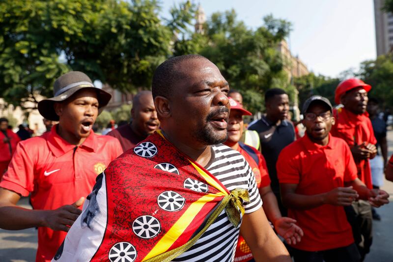 Members of the the Economic Freedom Fighters (EFF) gather at Church Square in Pretoria on March 20, 2023 during a "national shut-down" called by their party to bring the country to a halt.  (Photo by PHILL MAGAKOE  /  AFP)