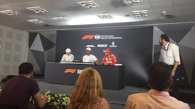 Lewis Hamilton, centre, after taking pole position in qualifying. Graham Caygill / The National