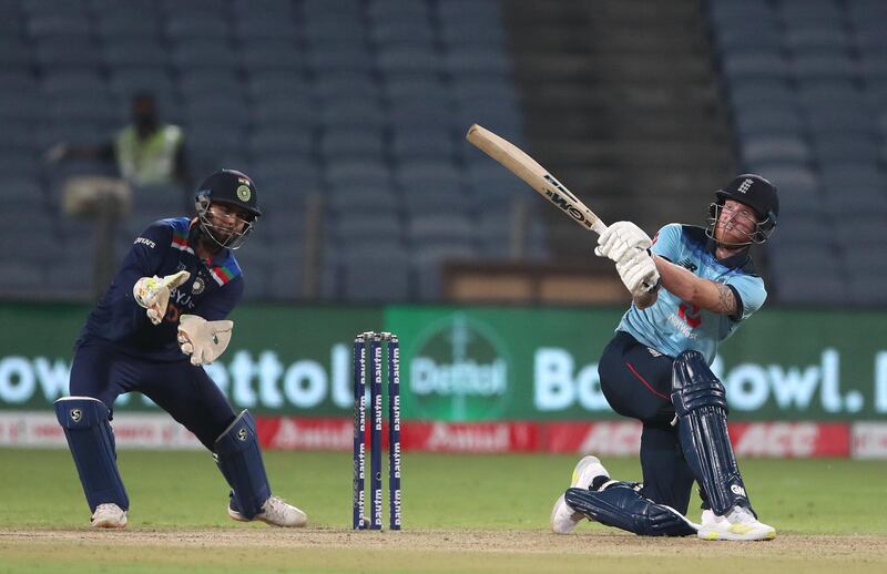 PUNE, INDIA - MARCH 26: England batsman Ben Stokes hits out watched by India wicketkeeper Rishabh Pant during the 2nd One Day International between India and England at MCA Stadium on March 26, 2021 in Pune, India. (Photo by Surjeet Yadav/Getty Images)