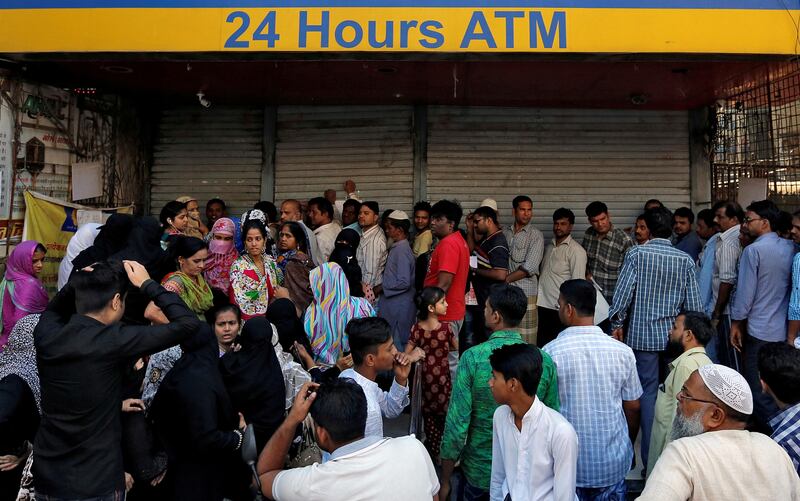 People queue outside a bank to withdraw cash and deposit their old high denomination banknotes in Mumbai, India, December 2, 2016. To match Insight INDIA-MODI/CORRUPTION  REUTERS/Danish Siddiqui/File Photo - RTSVBDM