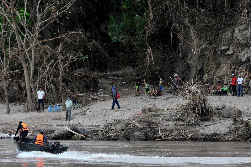 People in a boat wait to cross the Ulua river to evacuate from San Rafael colony before the arrival of hurricane Iota in Santa Barbara, Honduras. Getty