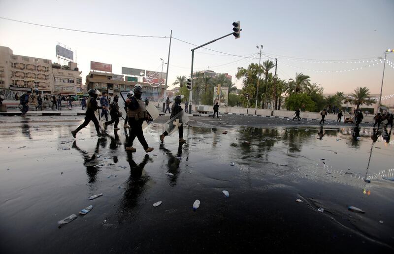 Riot police disperse people during the protest in Baghdad. Reuters