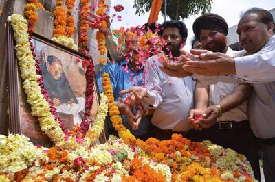People place flowers around a photograph of BR Ambedkar, a social reformer who was India's first law minister, in Amritsar in April. AFP