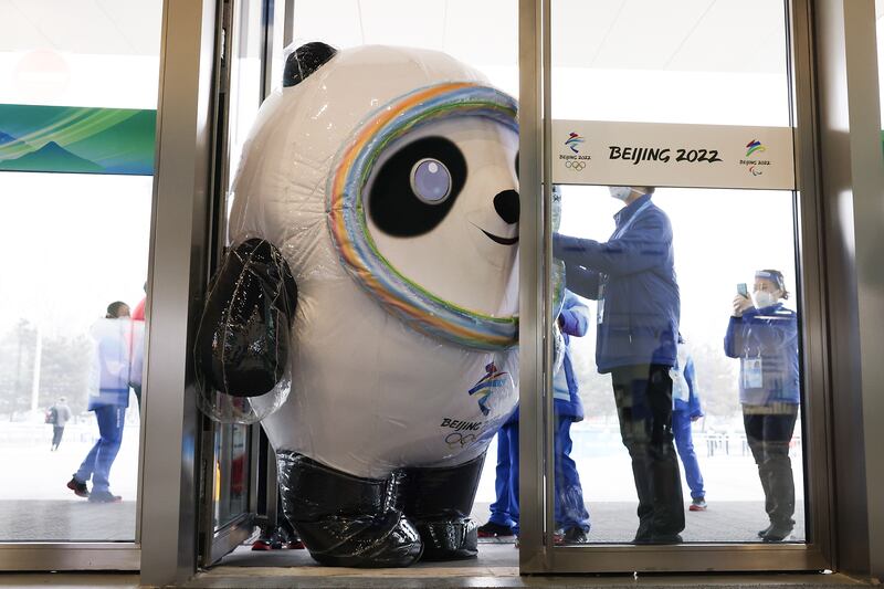 A staff member dressed as 2022 Winter Olympics mascot Bing Dwen Dwen gets stuck in a door at the media Centre in Beijing, where the Games start on February 4. Getty Images