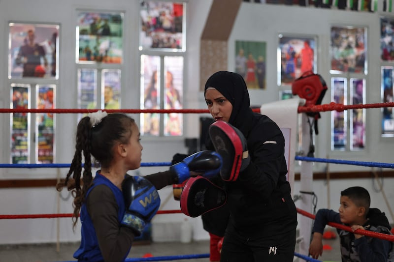 Palestinian girls practise boxing at the first women's boxing training club in Gaza City, on December 16, 2022.  (Photo by MOHAMMED ABED  /  AFP)