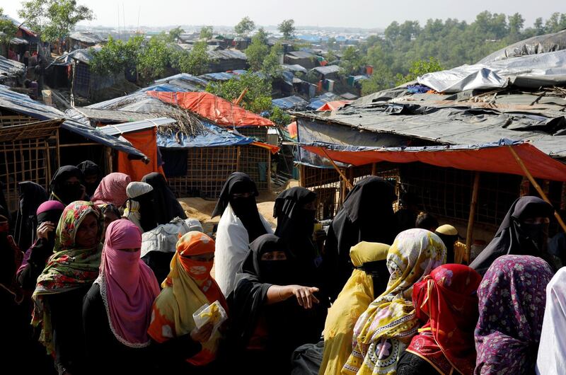Rohingya refugee women wait in line for aid in front of shelters at Kutupalong refugee camp, near Cox's Bazar, Bangladesh, January 4, 2018. REUTERS/Tyrone Siu
