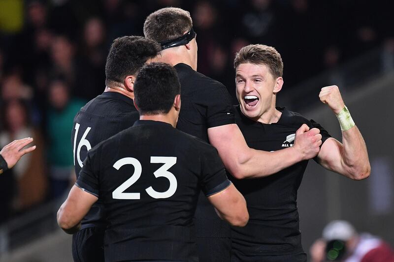 New Zealand's Beauden Barrett (R) celebrates a try with teammates Anton Lienert-Brown (L) and Scott Barrett during the second Bledisloe Cup match between New Zealand and Australia under their Rugby Championship test, at Forsyth Barr Stadium in Dunedin on August 26, 2017. / AFP PHOTO / Marty MELVILLE