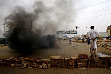 A Sudanese protester stands near a barricade in Khartoum. Reuters