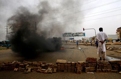 A Sudanese protester stands near a barricade on a street, demanding that the country's Transitional Military Council handover power to civilians, in Khartoum, Sudan June 4, 2019. REUTERS/Stringer